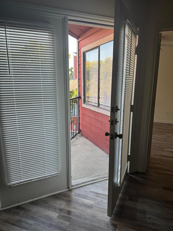 9825 Walnut Street, Unit 305 Dallas, TX 75243 - Photo 6 of 9 a view of a hallway with wooden floor and staircase