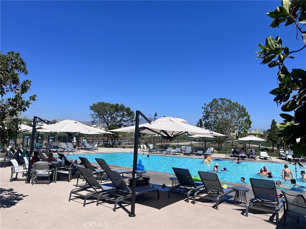 215 Sash Irvine, CA 92618 - Photo 13 of 31 a view of a patio with table and chairs under an umbrella with palm trees