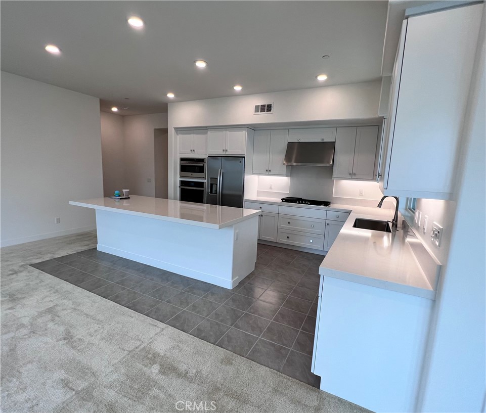 215 Sash Irvine, CA 92618 - Photo 2 of 31 a large kitchen with a large counter top furniture a fireplace and a counter top space