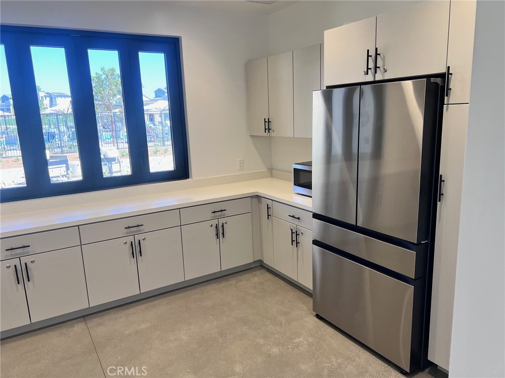 215 Sash Irvine, CA 92618 - Photo 30 of 31 a kitchen with white cabinets and white stainless steel appliances