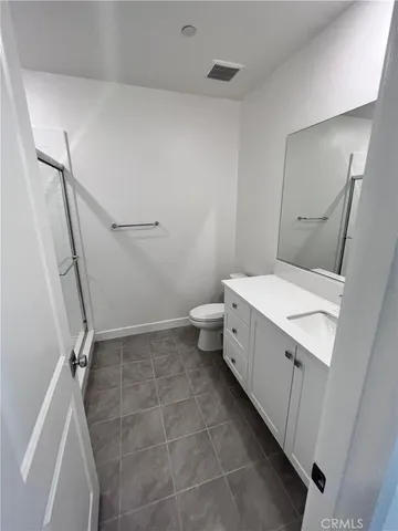a bathroom with a sink a toilet and a shower