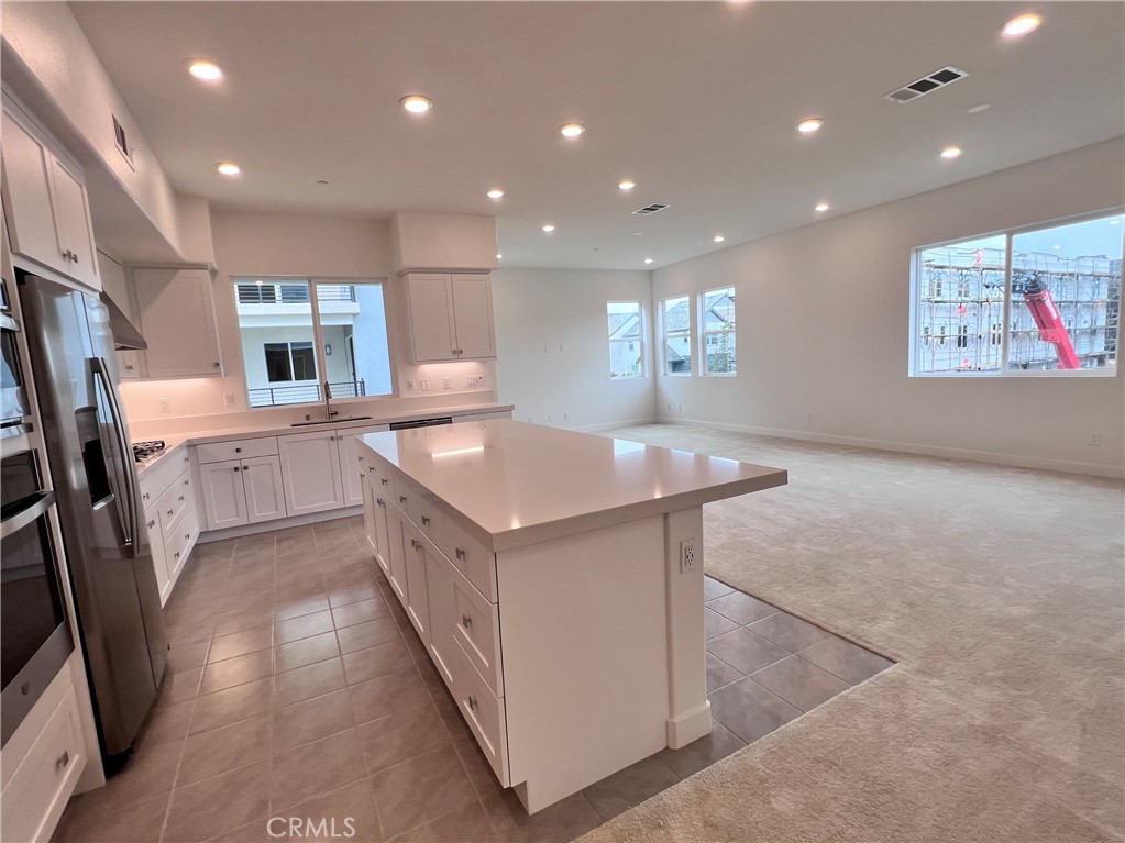 215 Sash Irvine, CA 92618 - Photo 8 of 31 a kitchen with stainless steel appliances granite countertop a sink and a refrigerator