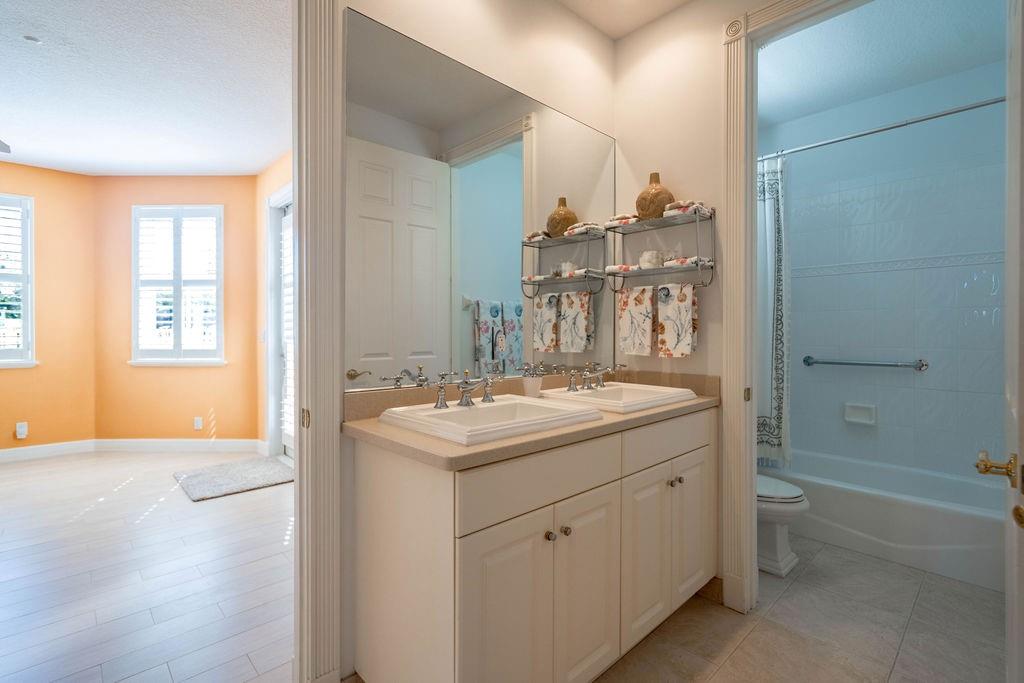 2825 Marina Circle, Unit 2825 Lighthouse Point, FL 33064 - Photo 11 of 48 a bathroom with a sink and a mirror