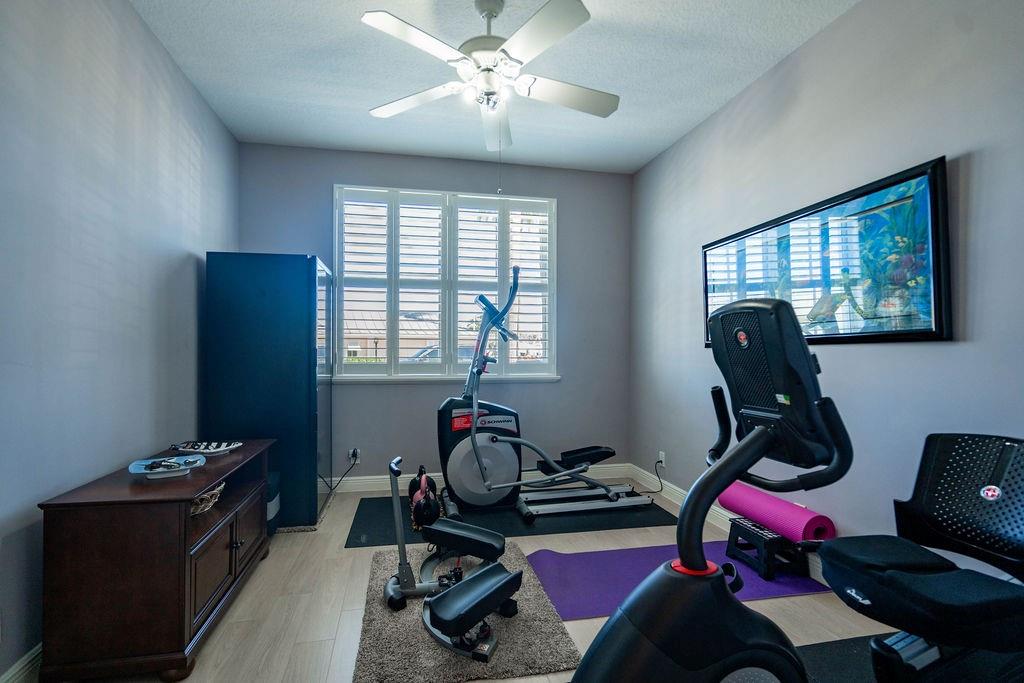 2825 Marina Circle, Unit 2825 Lighthouse Point, FL 33064 - Photo 13 of 48 a room with gym equipment and windows