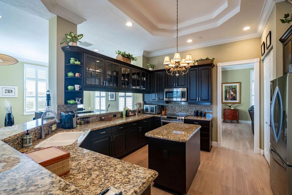 2825 Marina Circle, Unit 2825 Lighthouse Point, FL 33064 - Photo 23 of 48 a kitchen with a sink stove and refrigerator