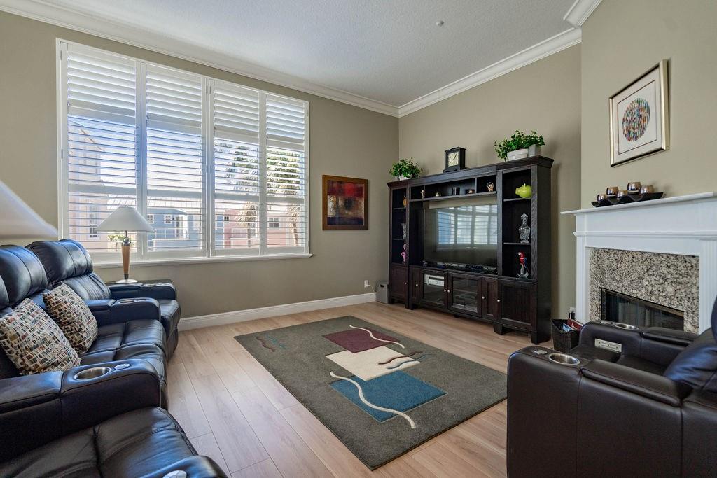 2825 Marina Circle, Unit 2825 Lighthouse Point, FL 33064 - Photo 27 of 48 a living room with furniture a flat screen tv and a fireplace