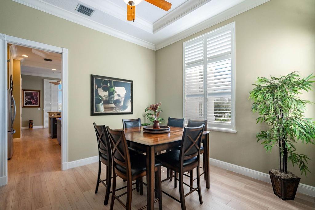 2825 Marina Circle, Unit 2825 Lighthouse Point, FL 33064 - Photo 28 of 48 a dining room with furniture and wooden floor