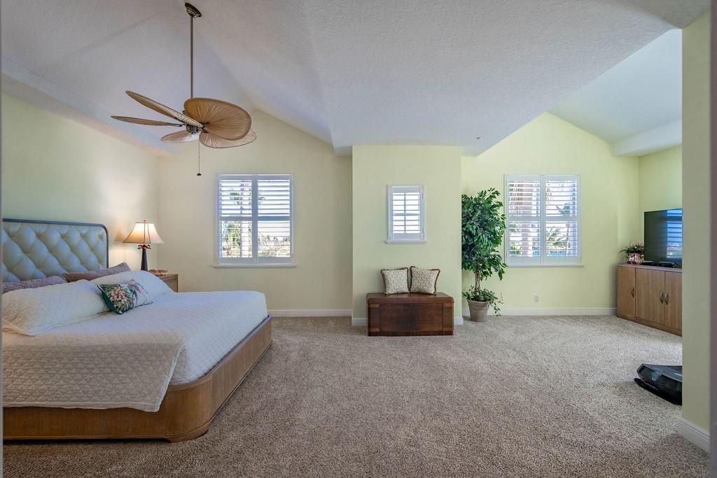 2825 Marina Circle, Unit 2825 Lighthouse Point, FL 33064 - Photo 32 of 48 a bedroom with a bed a couch and a window