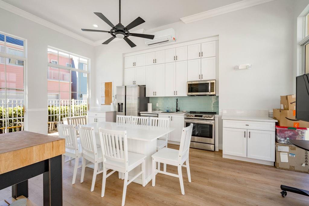 2825 Marina Circle, Unit 2825 Lighthouse Point, FL 33064 - Photo 46 of 48 a kitchen with stainless steel appliances kitchen island granite countertop a dining table chairs and granite counter tops