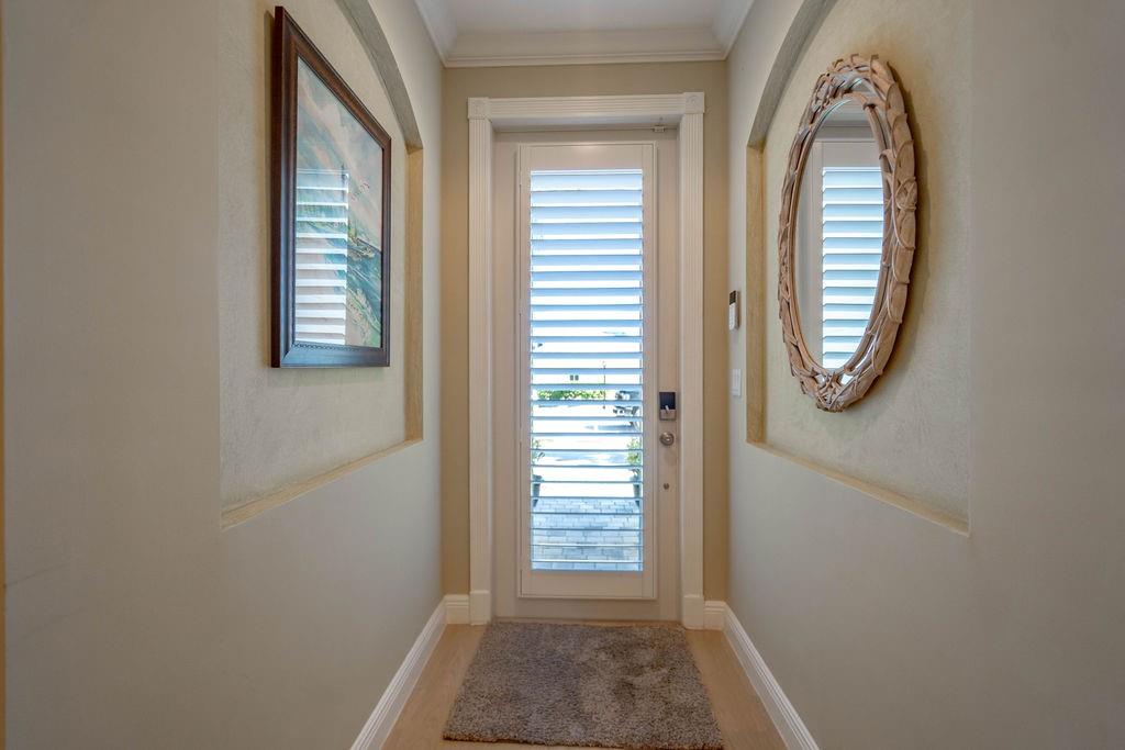 2825 Marina Circle, Unit 2825 Lighthouse Point, FL 33064 - Photo 8 of 48 an entryway with wooden floor mirror and windows