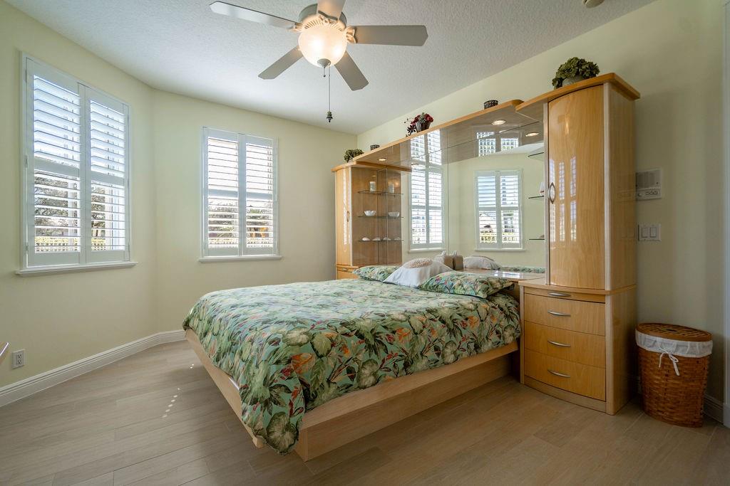 2825 Marina Circle, Unit 2825 Lighthouse Point, FL 33064 - Photo 9 of 48 a bedroom with a bed dresser and a window