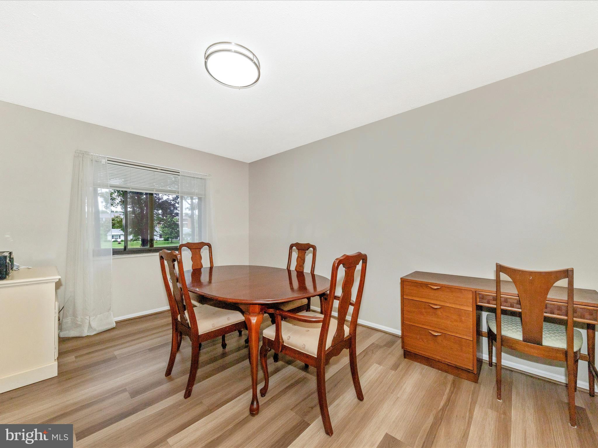 15101 Interlachen Drive, Unit 1116 Silver Spring, MD 20906 - Photo 11 of 78 a dining room with furniture and wooden floor