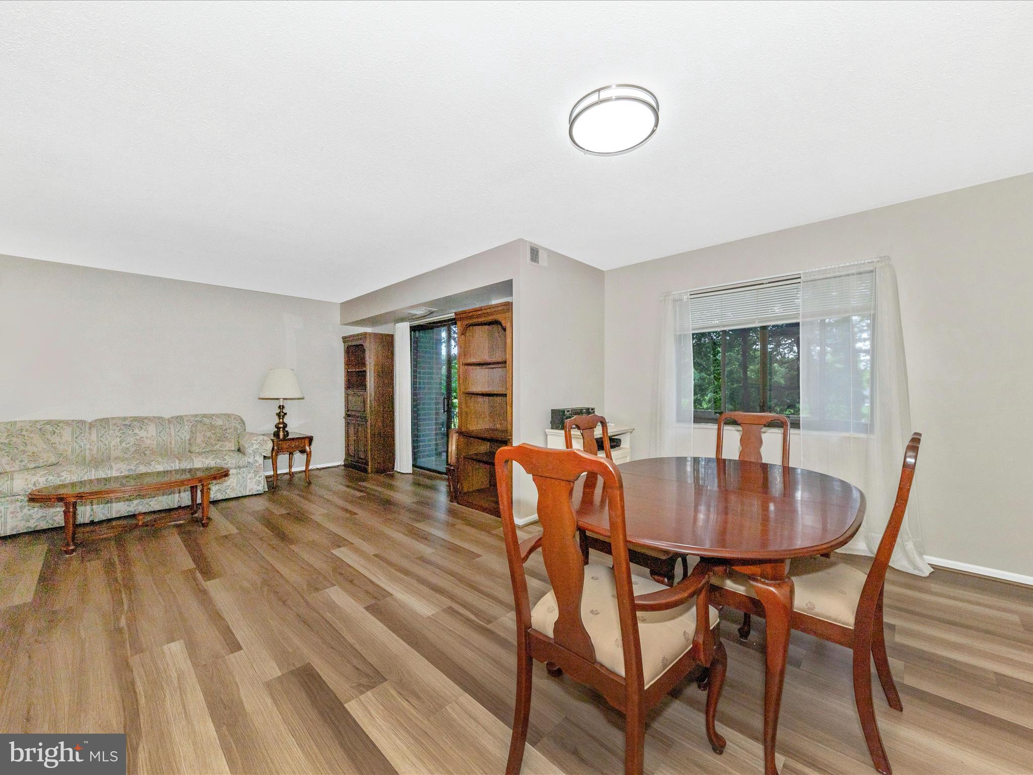 15101 Interlachen Drive, Unit 1116 Silver Spring, MD 20906 - Photo 12 of 78 a dining room with furniture and window