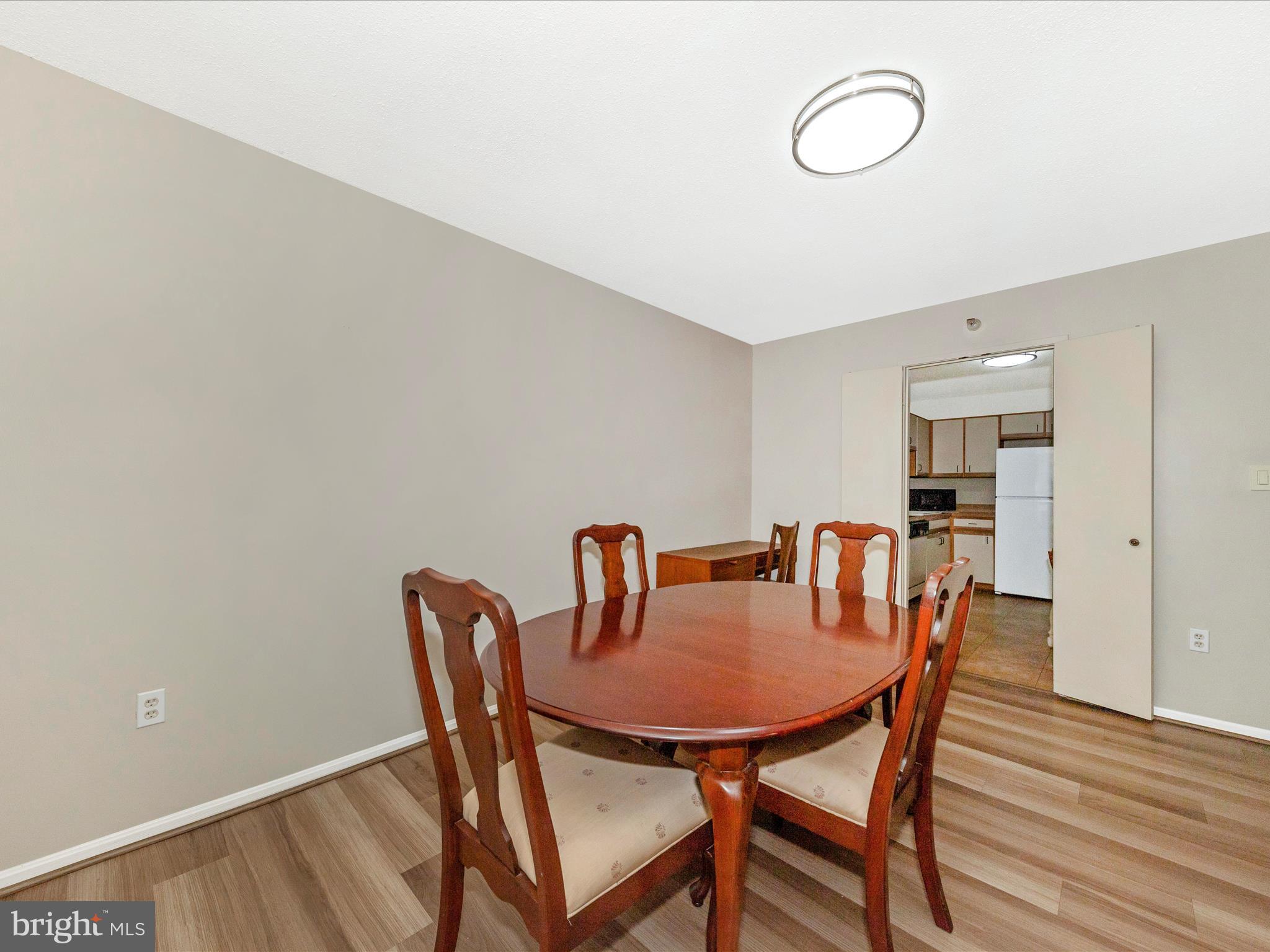 15101 Interlachen Drive, Unit 1116 Silver Spring, MD 20906 - Photo 14 of 78 a dining room with furniture and wooden floor
