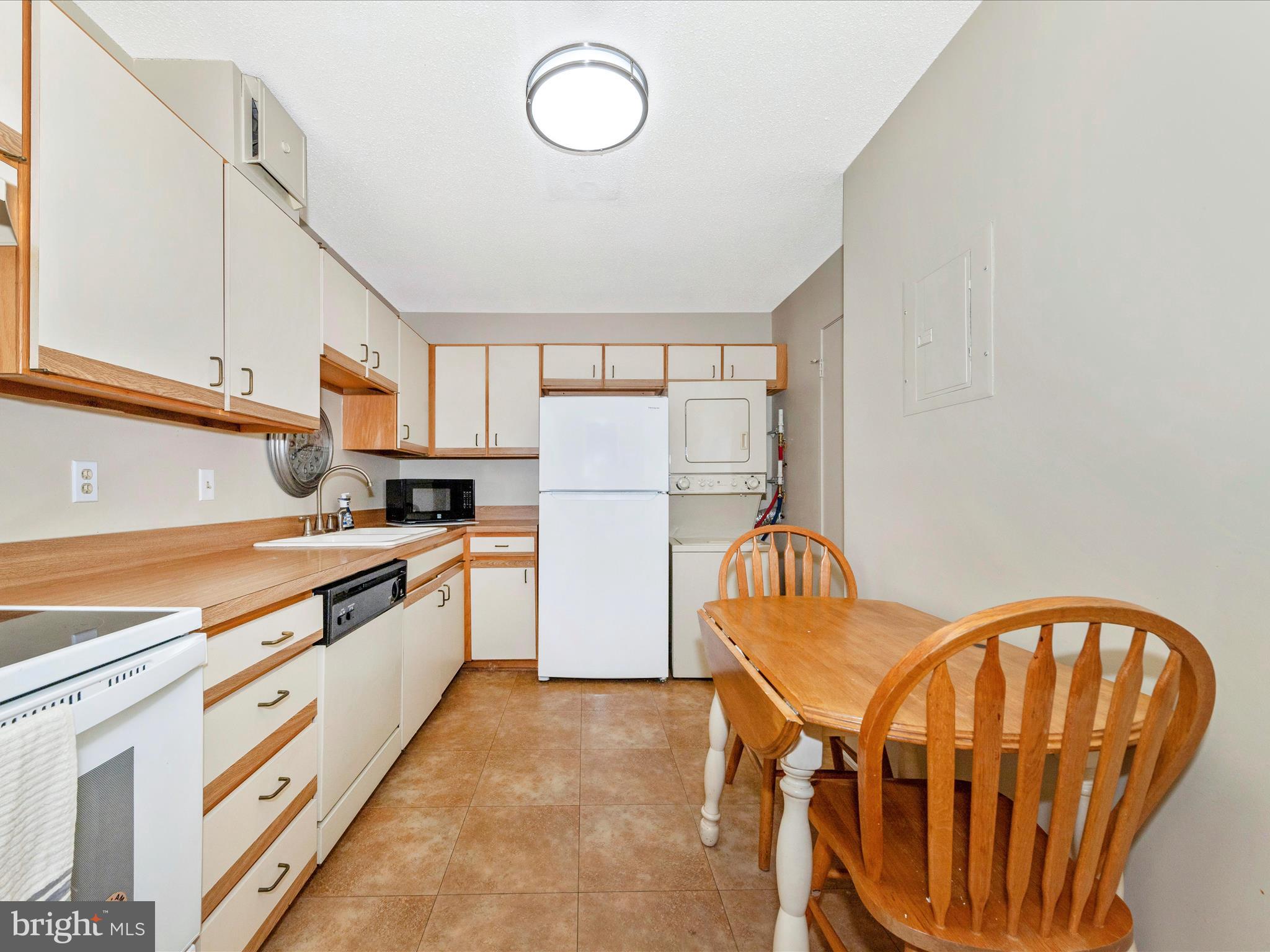 15101 Interlachen Drive, Unit 1116 Silver Spring, MD 20906 - Photo 15 of 78 a kitchen with stainless steel appliances granite countertop a refrigerator a stove a sink and a microwave