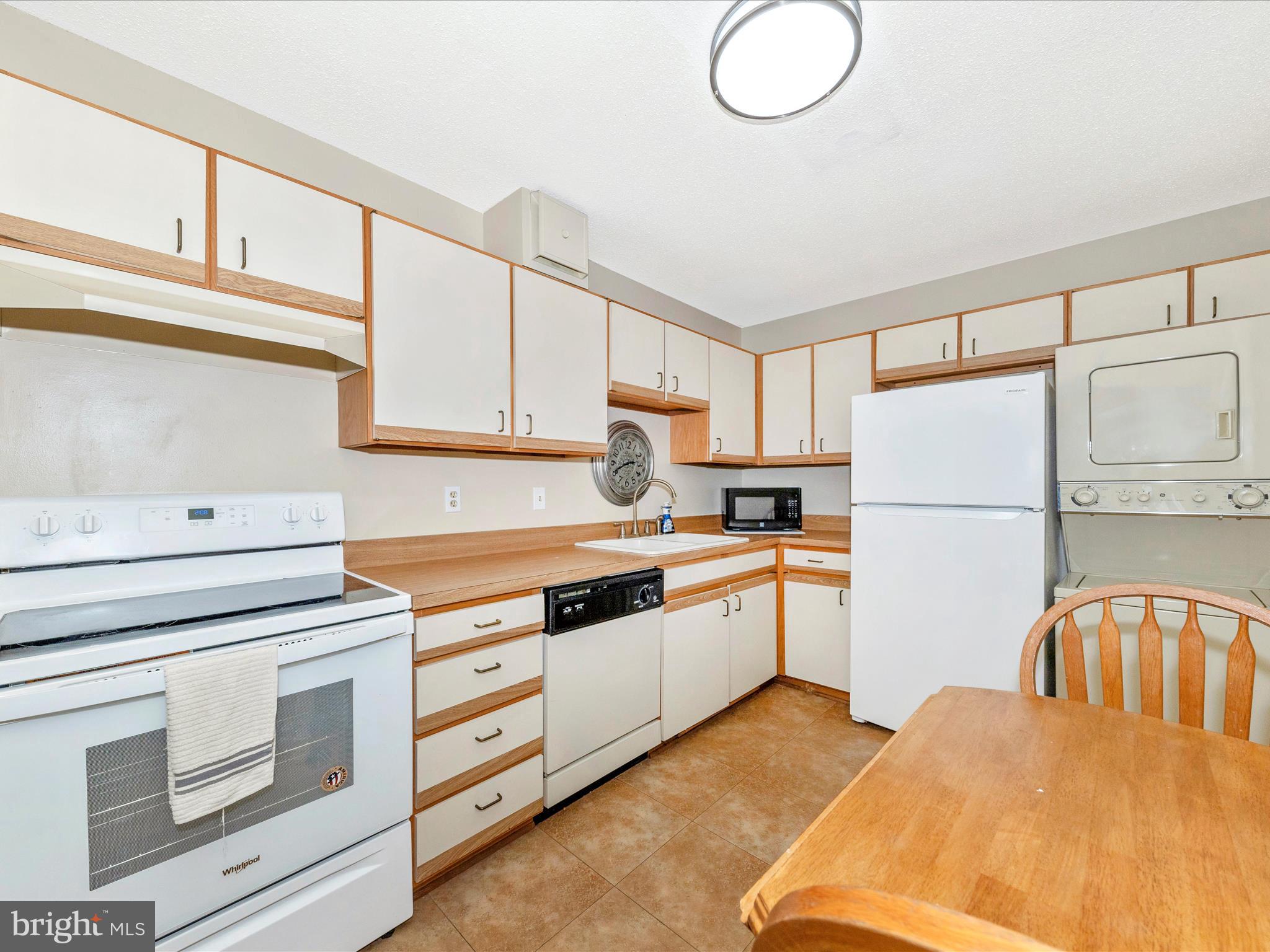 15101 Interlachen Drive, Unit 1116 Silver Spring, MD 20906 - Photo 16 of 78 a kitchen with stainless steel appliances granite countertop a stove a sink and a refrigerator
