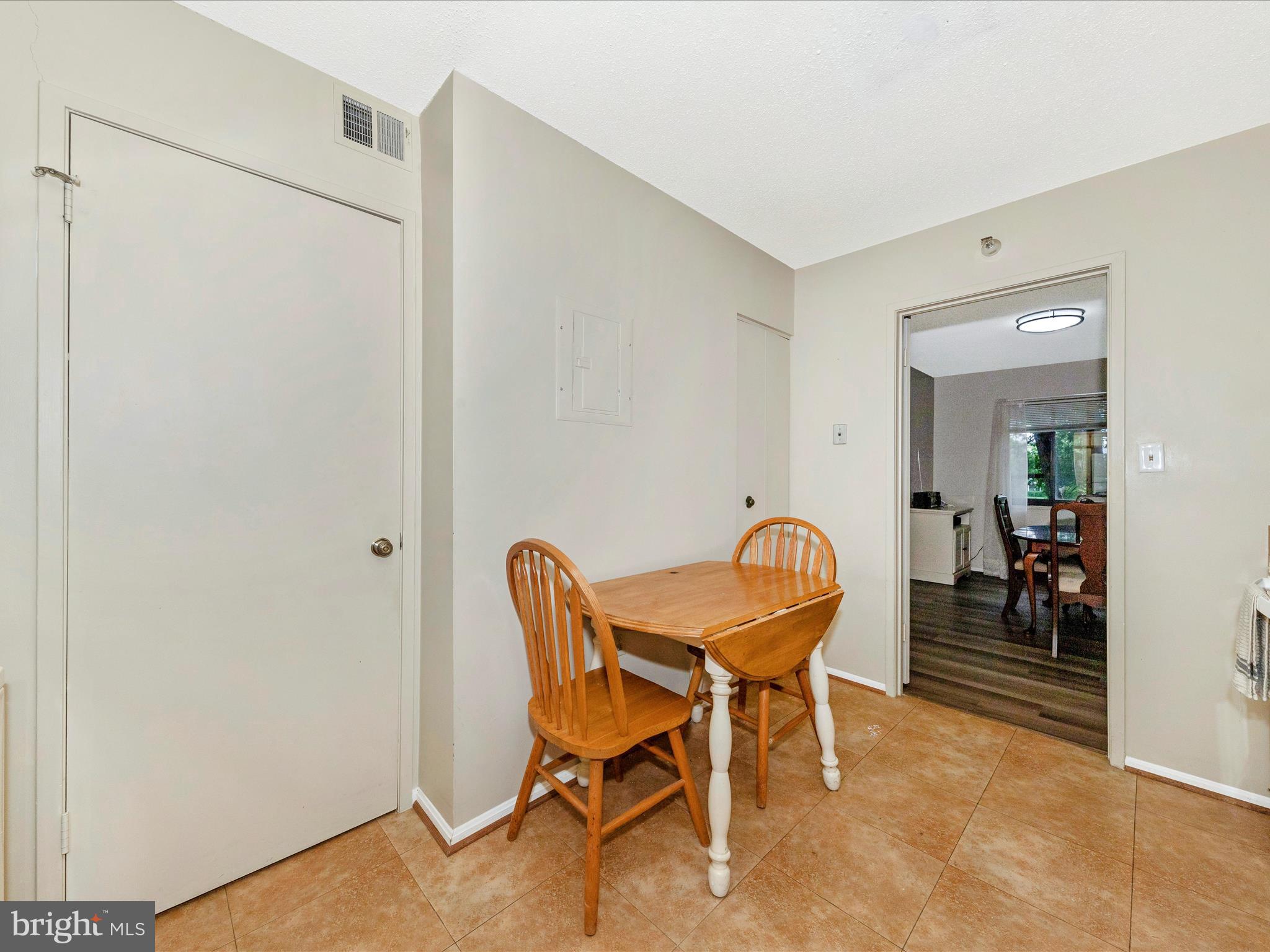 15101 Interlachen Drive, Unit 1116 Silver Spring, MD 20906 - Photo 19 of 78 a dining room with furniture and a window