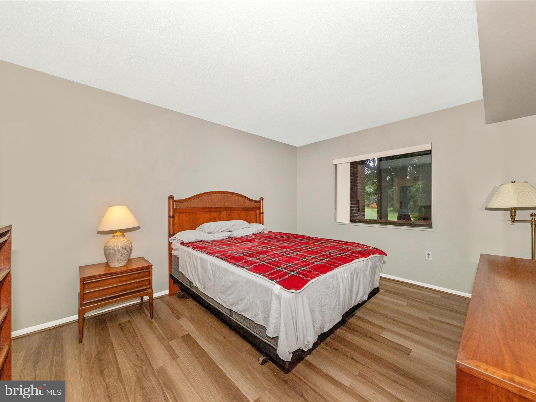 15101 Interlachen Drive, Unit 1116 Silver Spring, MD 20906 - Photo 22 of 78 a bedroom with a bed and wooden floor