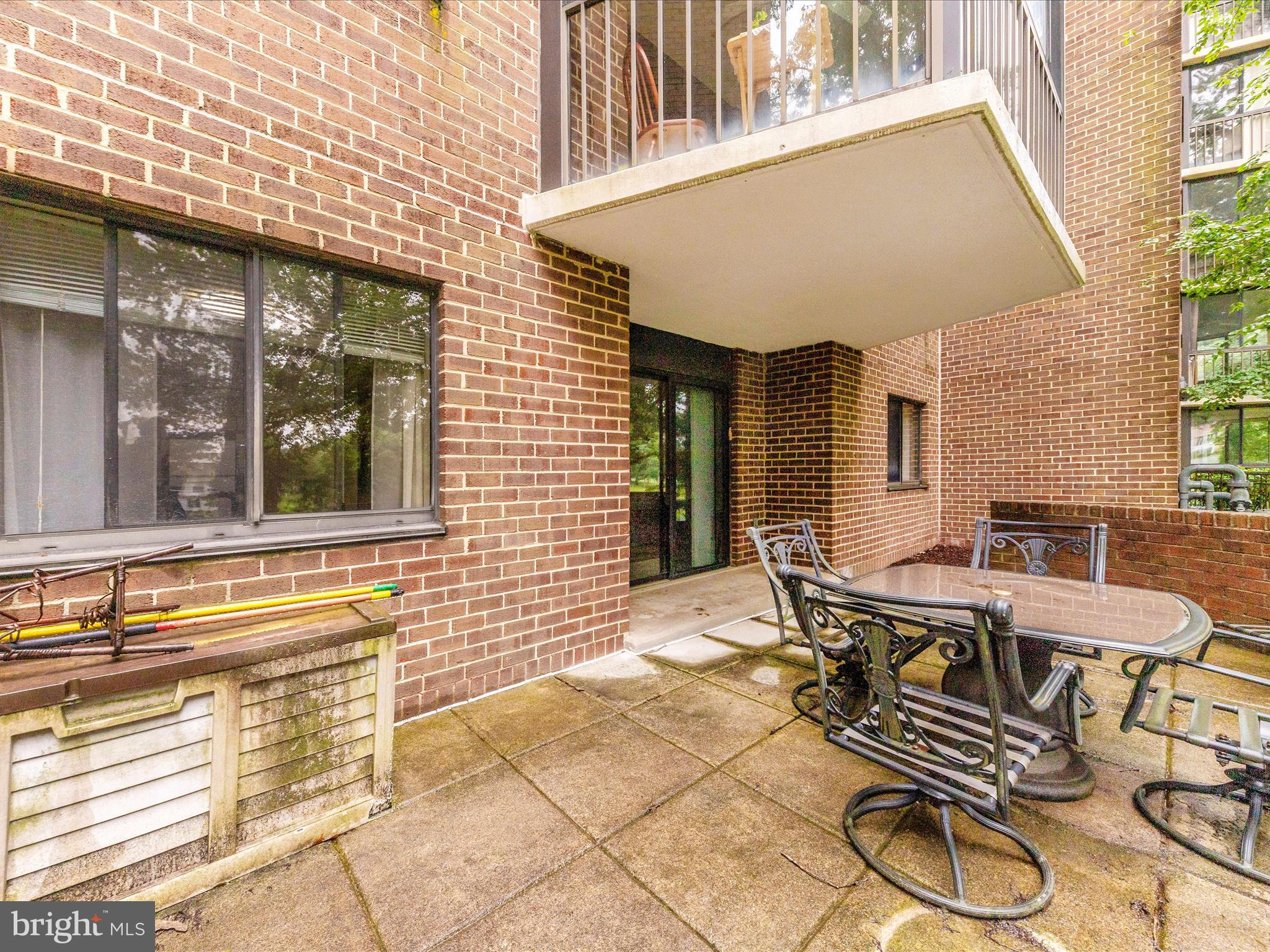 15101 Interlachen Drive, Unit 1116 Silver Spring, MD 20906 - Photo 30 of 78 a view of a patio with table and chairs and wooden floor