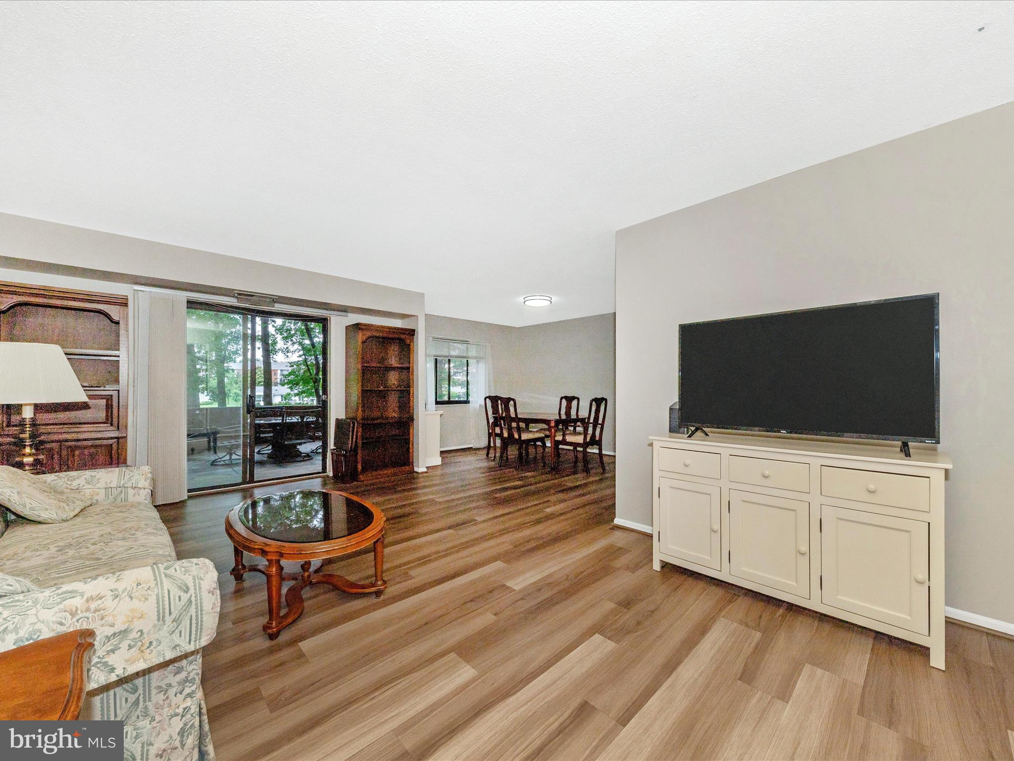 15101 Interlachen Drive, Unit 1116 Silver Spring, MD 20906 - Photo 5 of 78 a living room with furniture and a flat screen tv