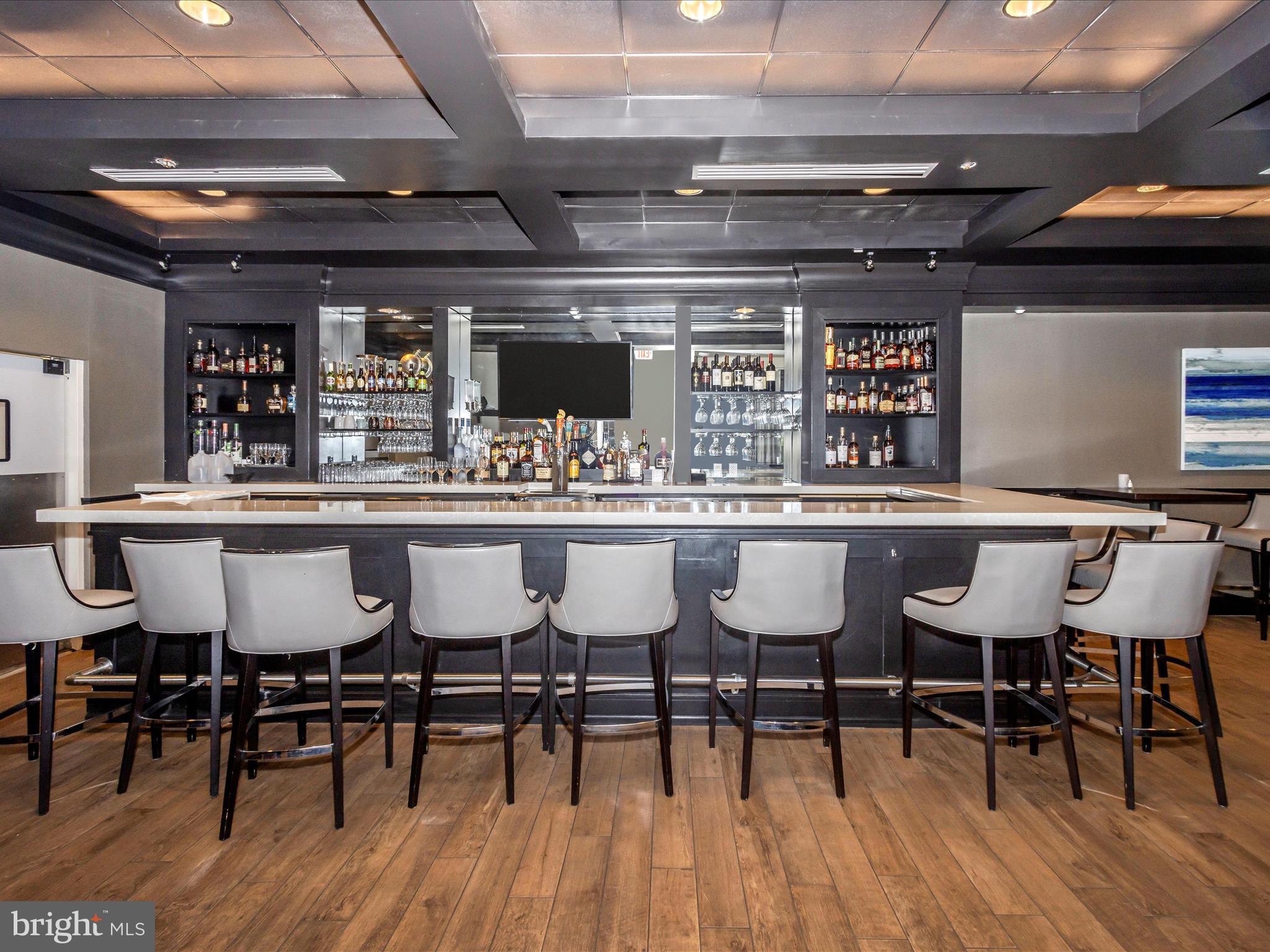 15101 Interlachen Drive, Unit 1116 Silver Spring, MD 20906 - Photo 56 of 78 a view of a dining room with furniture and wooden floor