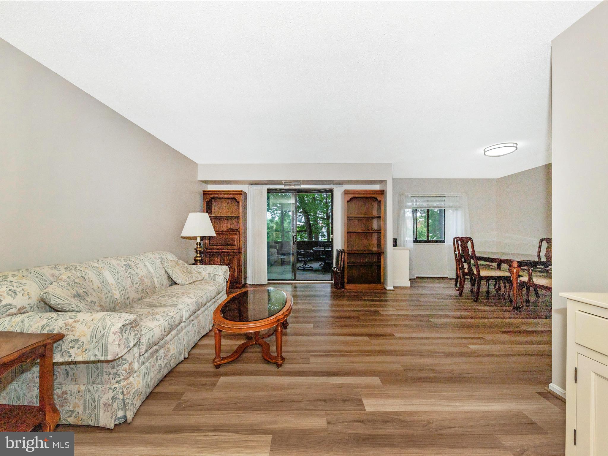 15101 Interlachen Drive, Unit 1116 Silver Spring, MD 20906 - Photo 6 of 78 a living room with furniture and wooden floor