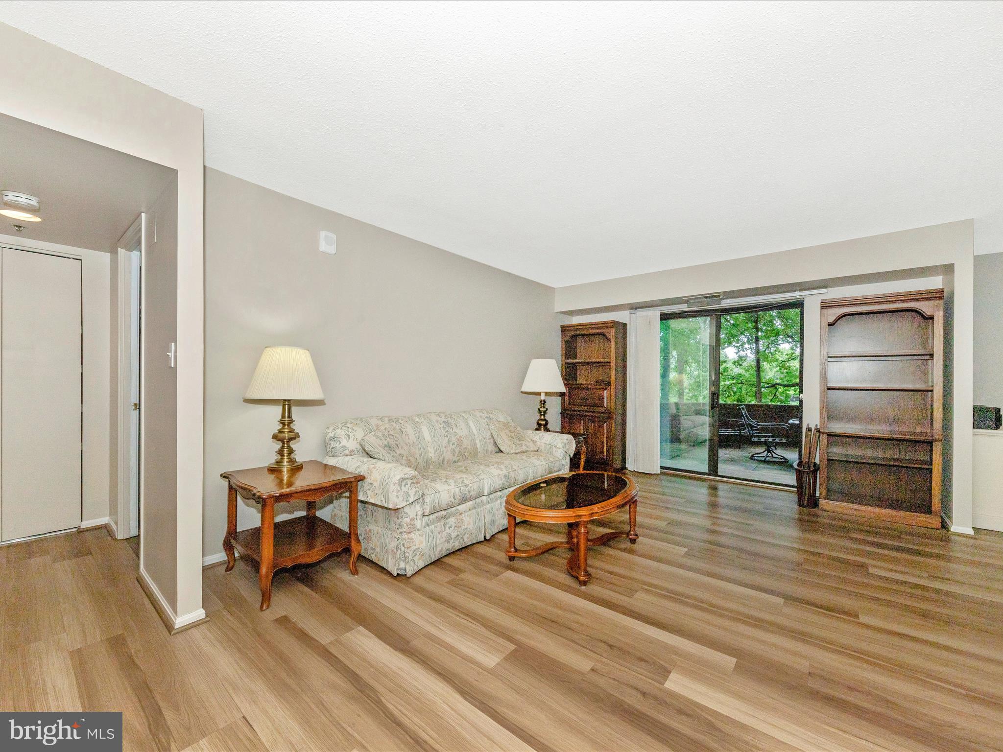 15101 Interlachen Drive, Unit 1116 Silver Spring, MD 20906 - Photo 7 of 78 a living room with furniture and a wooden floor