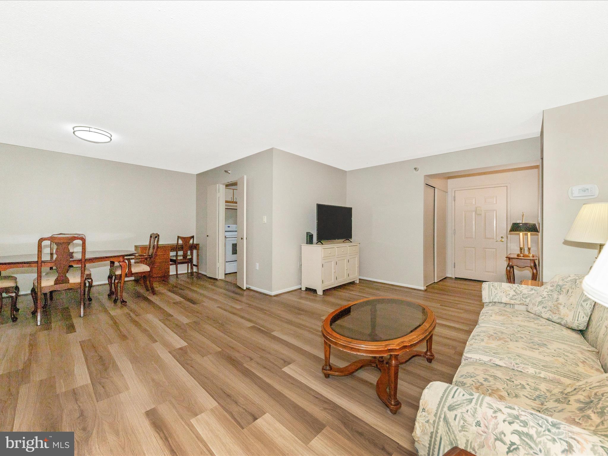 15101 Interlachen Drive, Unit 1116 Silver Spring, MD 20906 - Photo 8 of 78 a living room with furniture and a table