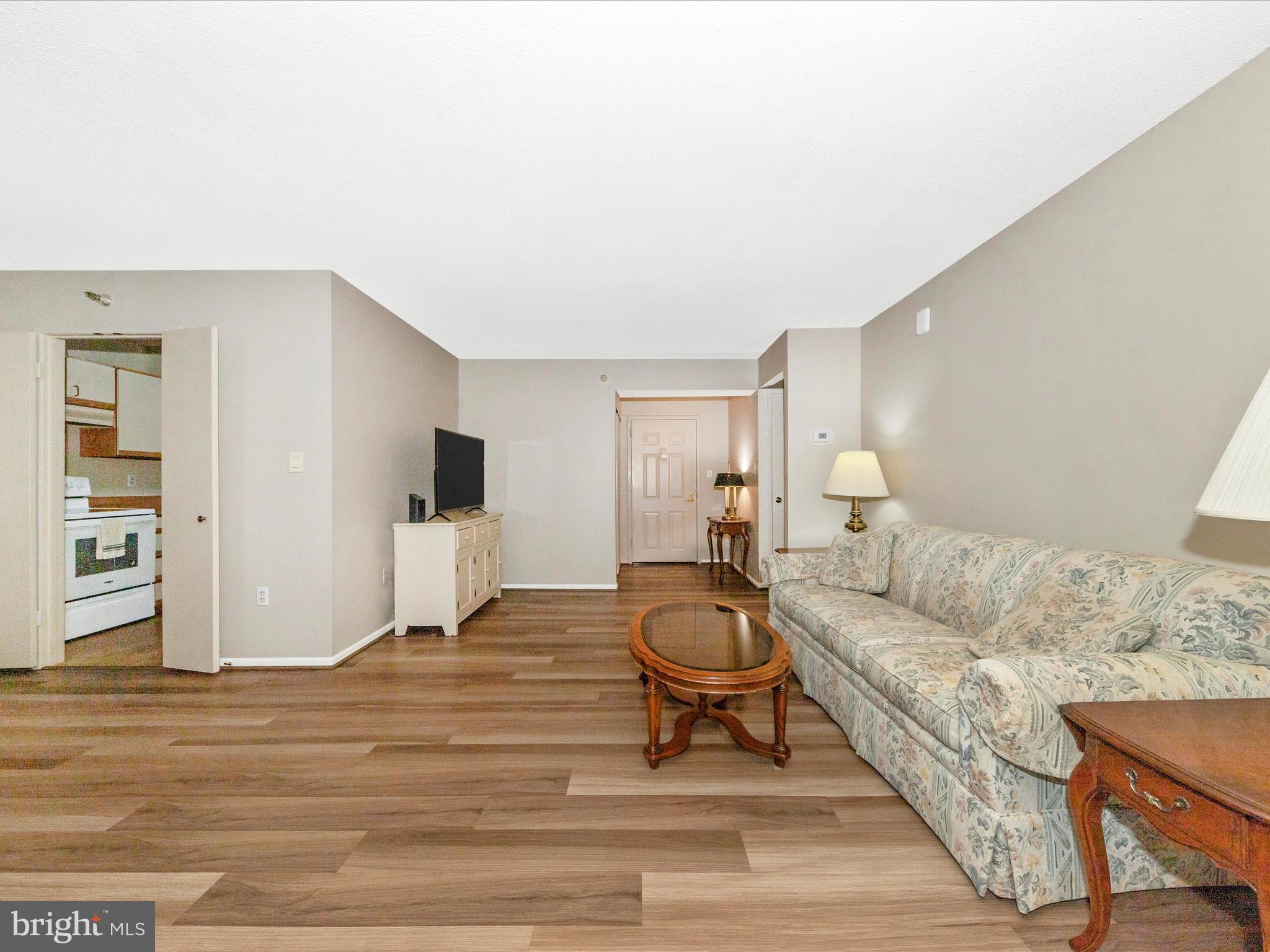 15101 Interlachen Drive, Unit 1116 Silver Spring, MD 20906 - Photo 9 of 78 a living room with furniture and a wooden floor