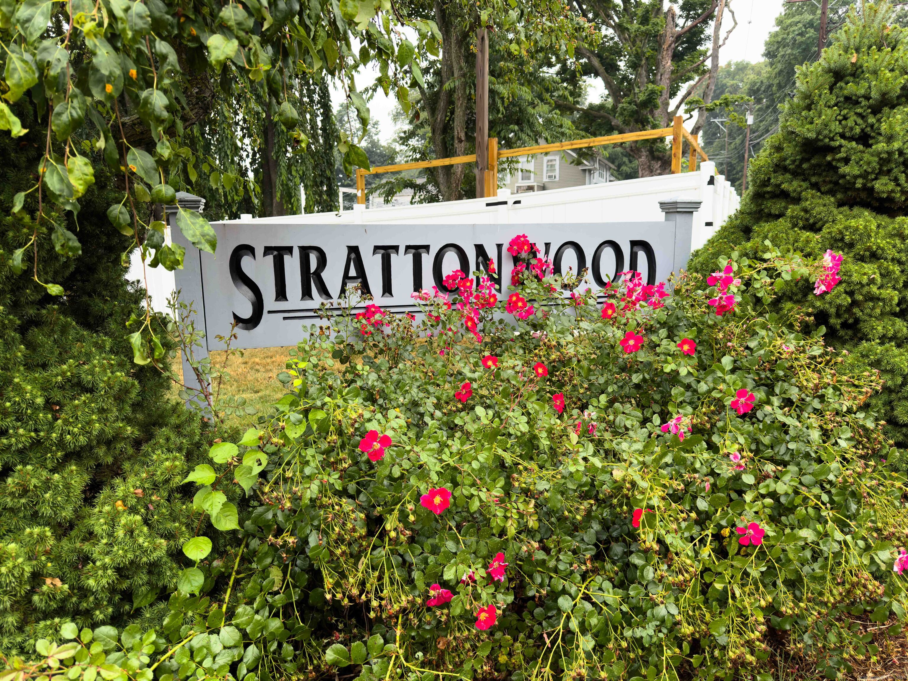 51 Stratton Way, Unit 51 Branford, CT 06405 - Photo 1 of 1 a sign that is in front of flowers