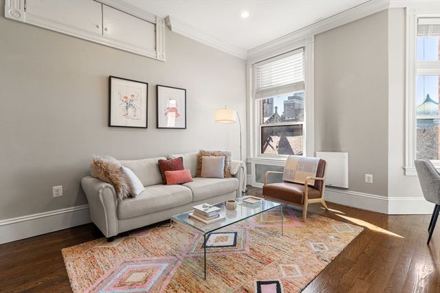 a living room with furniture wooden floor and a table
