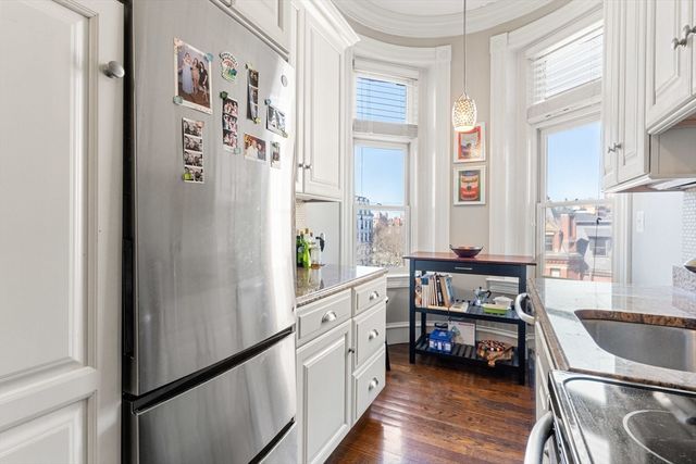 a kitchen with stainless steel appliances a refrigerator and a stove