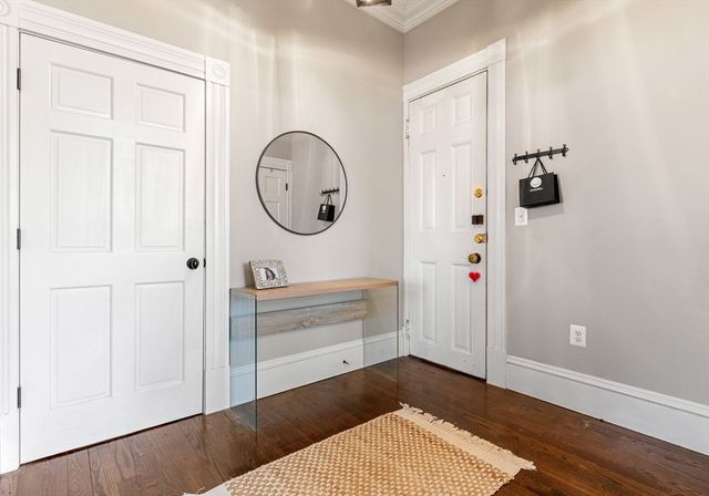 a room with a wooden floor and white walls