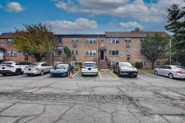 a view of cars parked in front of a house