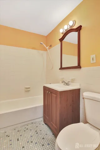 a bathroom with a toilet a sink and bathtub