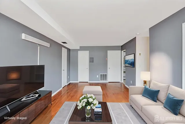 a spacious bedroom with a bed and a flat screen tv