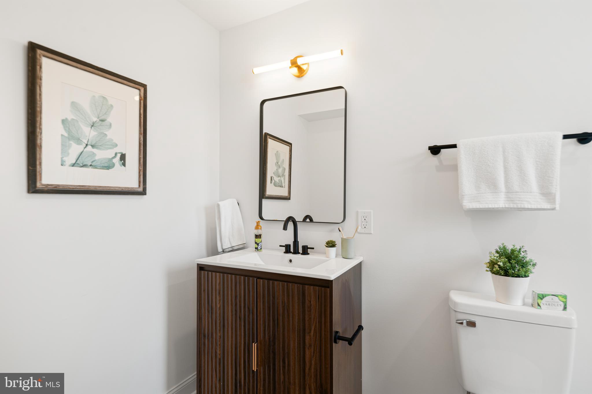 914 Moore Street Philadelphia, PA 19148 - Photo 16 of 26 a bathroom with a sink mirror and vanity