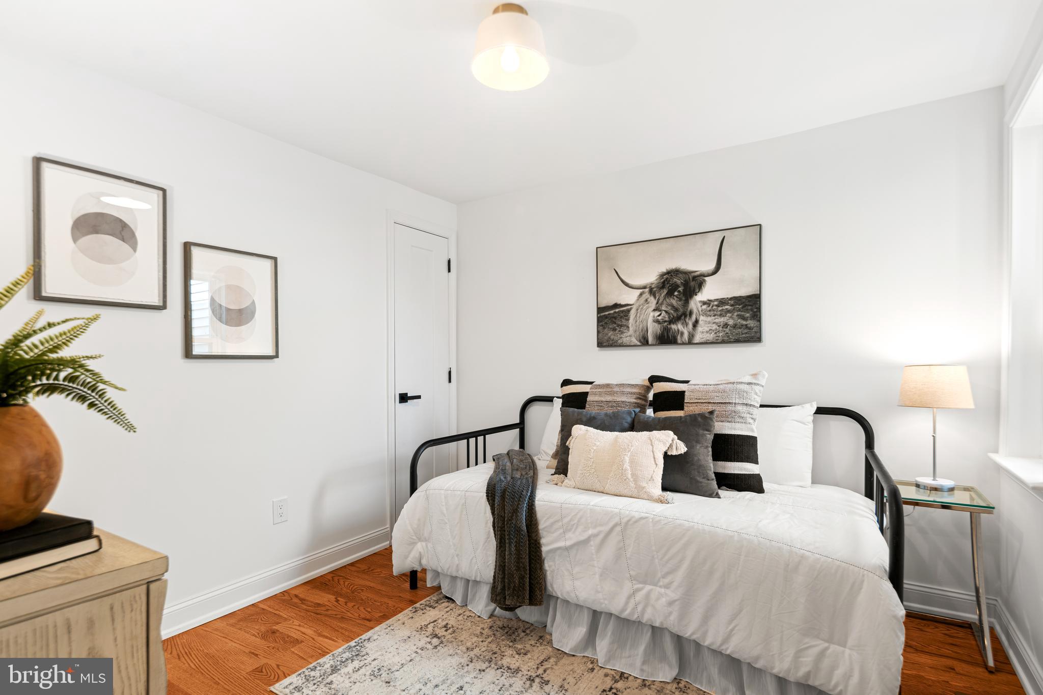 914 Moore Street Philadelphia, PA 19148 - Photo 18 of 26 a bedroom with bed and a night stand
