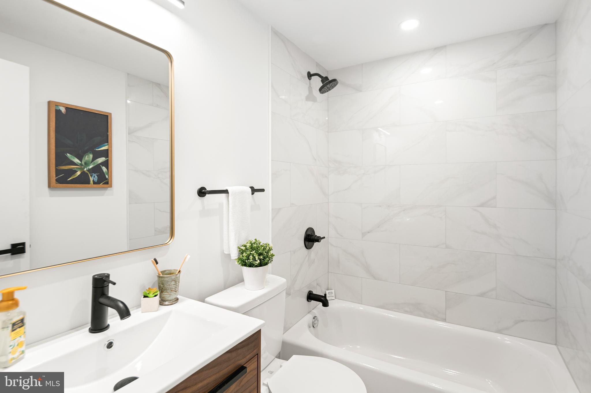 914 Moore Street Philadelphia, PA 19148 - Photo 20 of 26 a bathroom with a sink toilet and shower