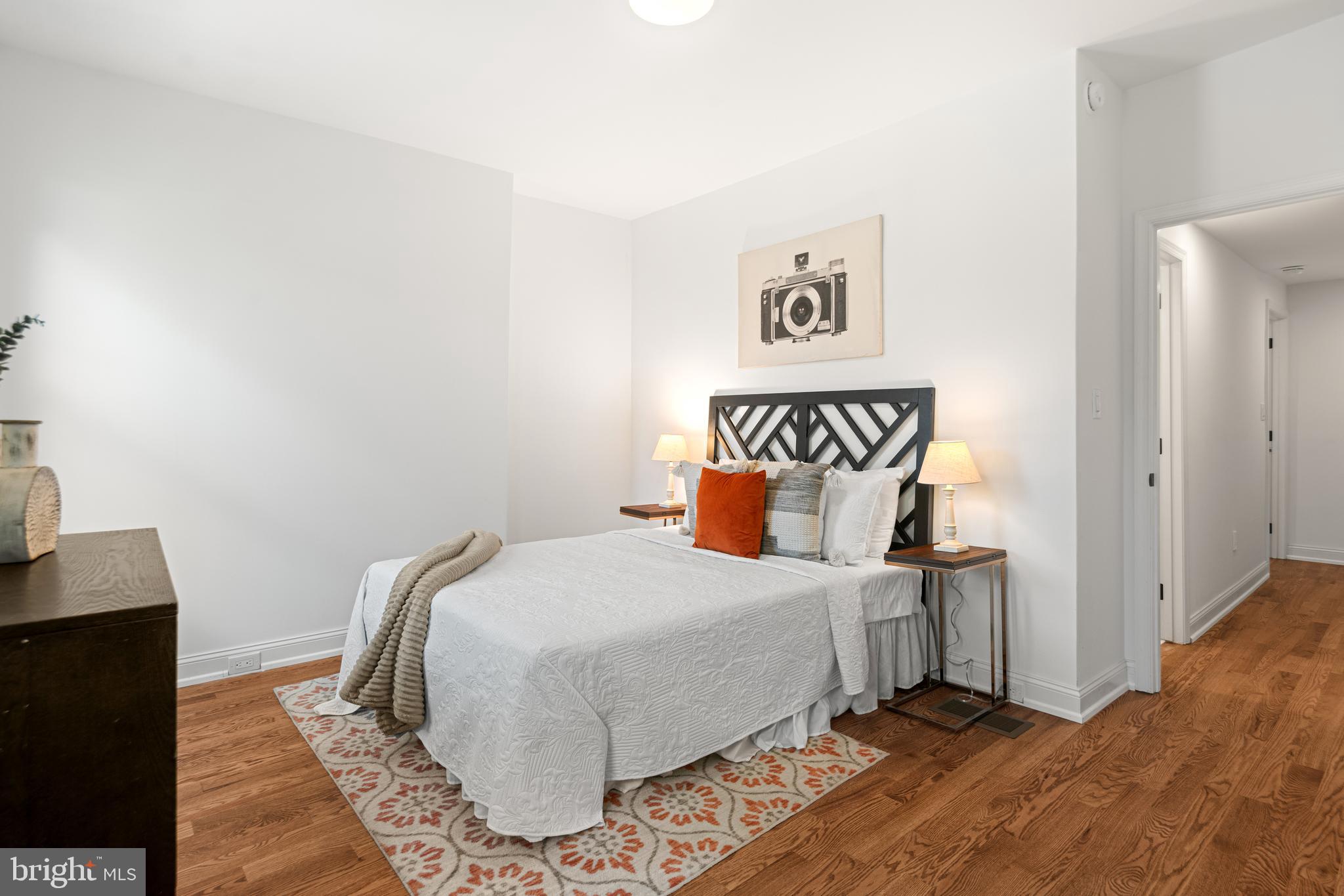 914 Moore Street Philadelphia, PA 19148 - Photo 22 of 26 a bedroom with a bed and a table in it