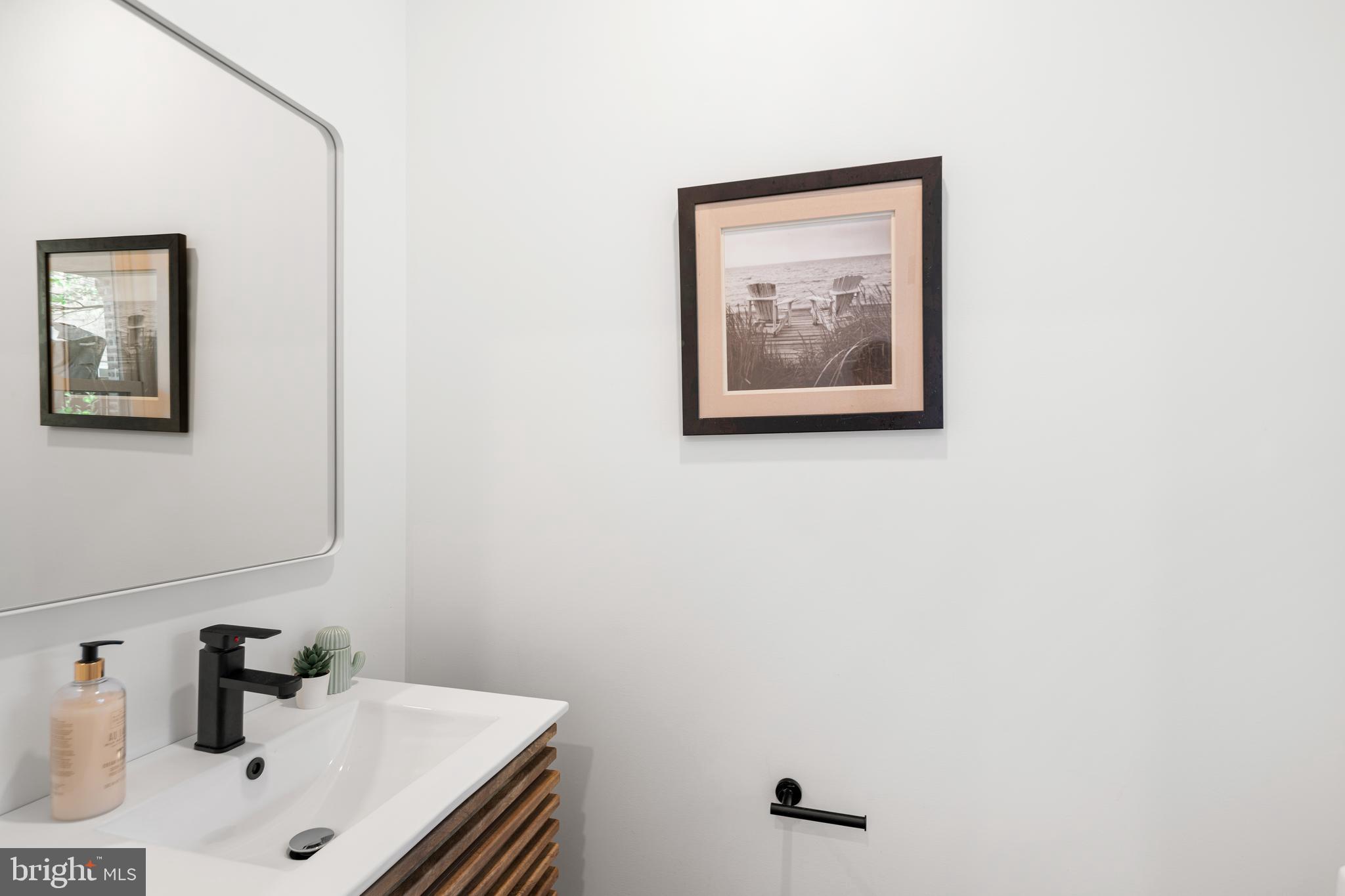 914 Moore Street Philadelphia, PA 19148 - Photo 10 of 26 a bathroom with a sink and a mirror