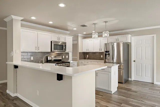 a kitchen with sink stove and cabinets