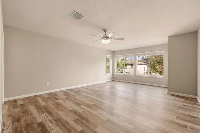 wooden floor in an empty room with a window