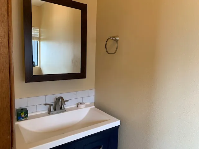 a bathroom with a sink and a mirror
