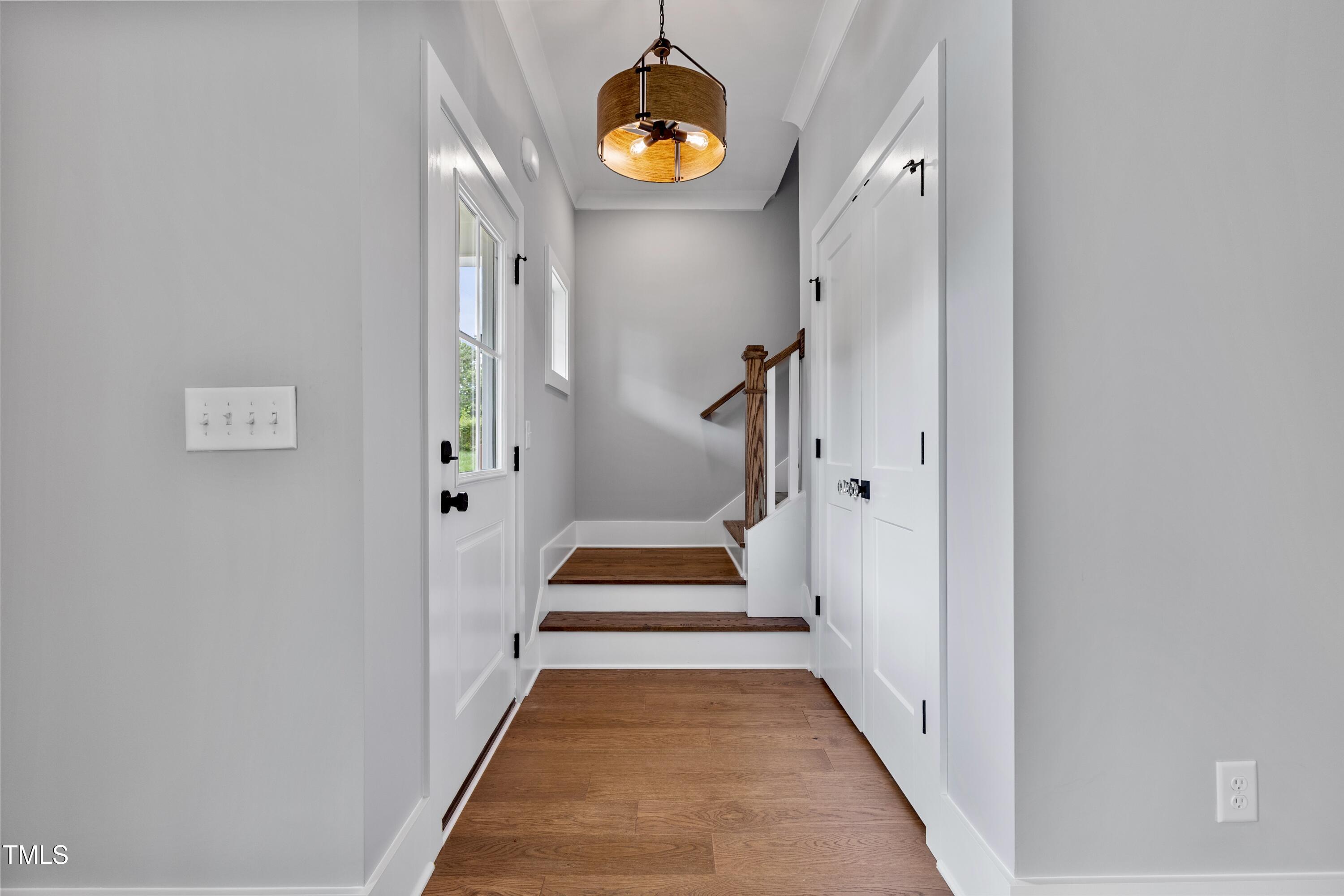 2521 Newbold Street Raleigh, NC 27603 - Photo 21 of 40 a view of a hallway with wooden floor and white walls