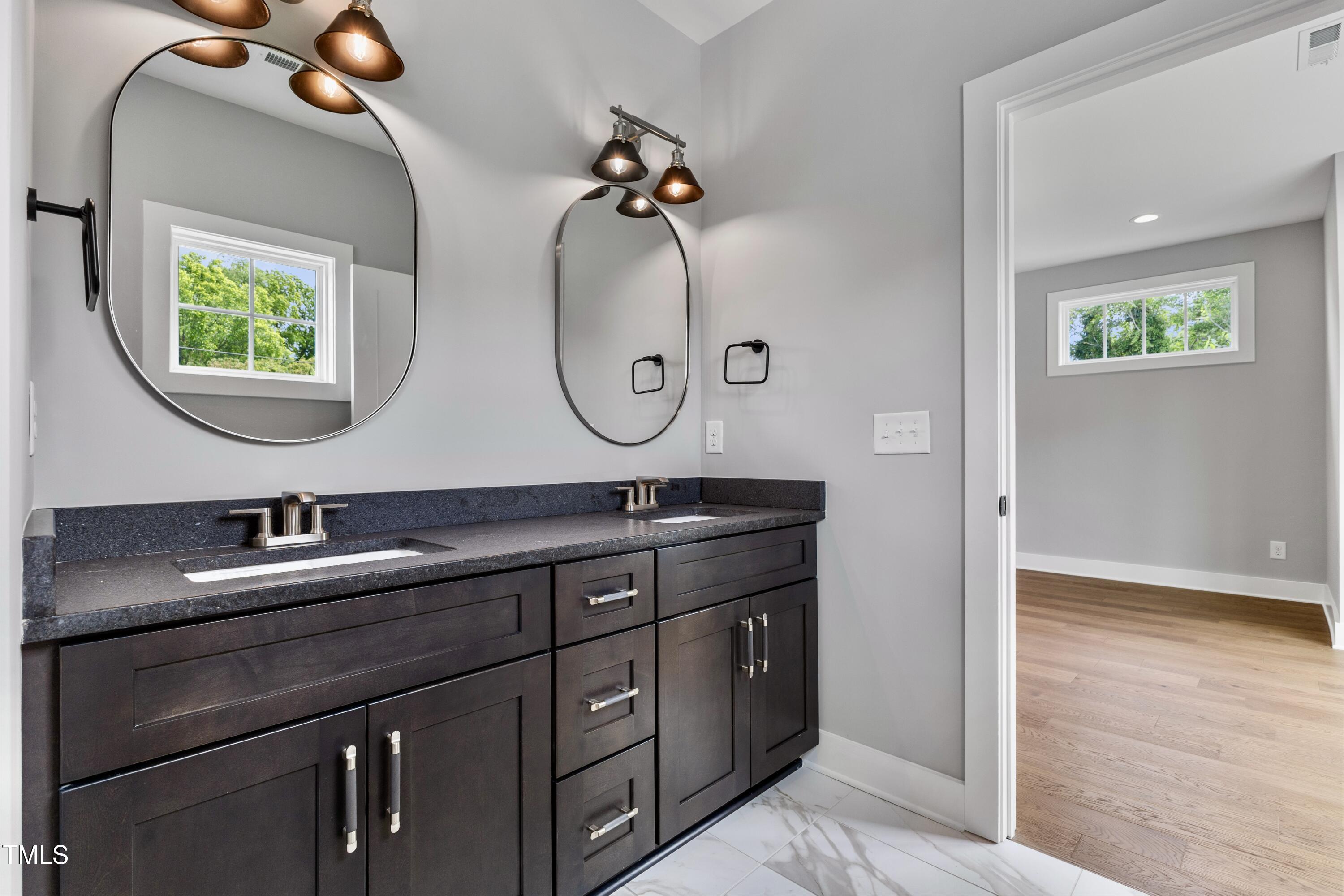 2521 Newbold Street Raleigh, NC 27603 - Photo 25 of 40 a bathroom with a sink and a mirror