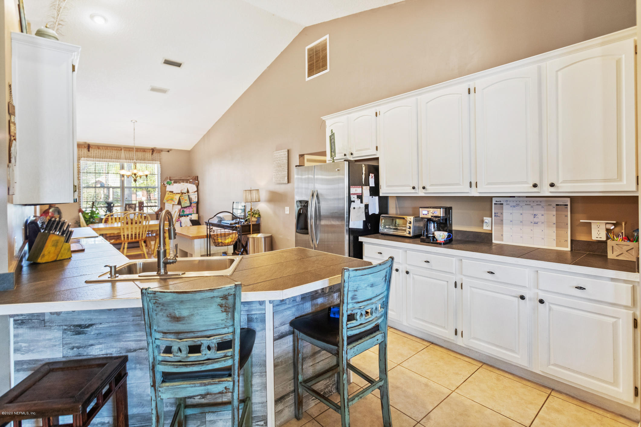 54324 Cravey Road Callahan, FL 32011 - Photo 27 of 48 a large kitchen with granite countertop a stove a sink a dining table and chairs