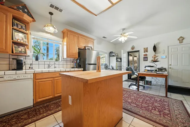 a kitchen with cabinets and chairs