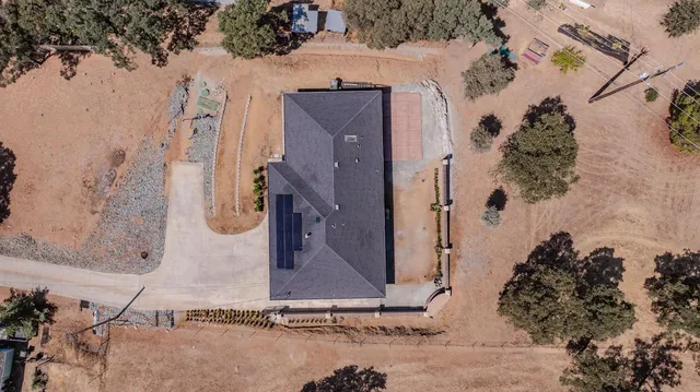 an aerial view of a house with a yard