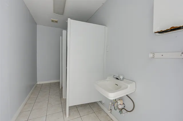 a view of a room with a wooden door